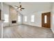 Spacious living room with a stone fireplace, vaulted ceiling, and modern flooring at 752 Chipmeadow Ln, York, SC 29745