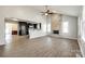 Open-concept living room with stone fireplace, modern floors, and a view into the kitchen at 752 Chipmeadow Ln, York, SC 29745