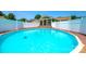 A backyard swimming pool surrounded by a wooden deck and white privacy fence at 752 Chipmeadow Ln, York, SC 29745