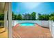 A refreshing pool surrounded by a wooden deck and a white privacy fence at 752 Chipmeadow Ln, York, SC 29745