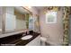 Well-lit bathroom featuring a granite countertop, ample mirror space, and modern decor at 107 Asmodean Ln, Troutman, NC 28166