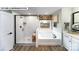 Bright bathroom featuring a glass shower, a separate tub, and modern fixtures at 109 Asmodean Ln, Troutman, NC 28166