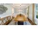 Spacious dining room with large table, modern lighting, and wainscoting at 109 Asmodean Ln, Troutman, NC 28166