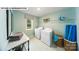 Functional laundry room with a washer, dryer, storage shelves, and a window for natural light at 109 Asmodean Ln, Troutman, NC 28166