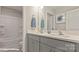 Bright bathroom boasting double sinks, gray cabinets, and a convenient shower-tub at 115 Asmodean Ln, Troutman, NC 28166