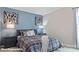 Stylish bedroom with cool-toned walls, modern art, and comfortable bedding at 115 Asmodean Ln, Troutman, NC 28166