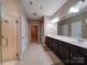 Spacious bathroom featuring double sink vanity, walk in shower and neutral tile flooring at 120 Autumn Mist Rd, Statesville, NC 28677