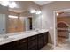 Bright bathroom with double sink vanity, large mirror and walk-in shower at 120 Autumn Mist Rd, Statesville, NC 28677