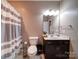 Well-lit bathroom with striped shower curtain and vanity at 120 Autumn Mist Rd, Statesville, NC 28677