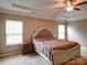 Carpeted bedroom with a tray ceiling, fan, and a large comfortable bed at 120 Autumn Mist Rd, Statesville, NC 28677