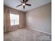 Comfortable carpeted bedroom with a ceiling fan and bright, natural light at 120 Autumn Mist Rd, Statesville, NC 28677