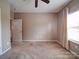 Bedroom featuring a ceiling fan and a bright window with lovely curtains at 120 Autumn Mist Rd, Statesville, NC 28677