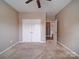 Neutral bedroom featuring a ceiling fan, carpet floors, and closet doors at 120 Autumn Mist Rd, Statesville, NC 28677
