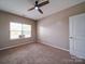Bedroom showcasing neutral walls, carpeting, ceiling fan, and a window at 120 Autumn Mist Rd, Statesville, NC 28677