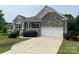 Charming home featuring stone accents, a two-car garage, and a welcoming front porch at 120 Autumn Mist Rd, Statesville, NC 28677
