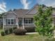Charming single-Gathering home with stone accents, landscaped yard, and inviting front porch with American flag at 120 Autumn Mist Rd, Statesville, NC 28677