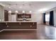 Bright kitchen features an island with granite countertops, wooden floors and stainless steel appliances at 120 Autumn Mist Rd, Statesville, NC 28677