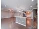 Open kitchen featuring hardwood floors and a large island with granite countertops at 120 Autumn Mist Rd, Statesville, NC 28677