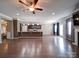 Open concept living area featuring hardwood floors, ceiling fan and view of the kitchen at 120 Autumn Mist Rd, Statesville, NC 28677