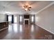 Spacious living room featuring a fireplace, ceiling fan, and beautiful hardwood floors at 120 Autumn Mist Rd, Statesville, NC 28677