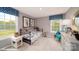Bright bedroom featuring neutral walls, plush carpet, and white trim, with two windows and colorful accents at 127 Asmodean Ln, Troutman, NC 28166