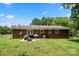 Backyard featuring a brick home and a patio area with a grill at 128 Wandering Ln, Bessemer City, NC 28016