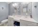 The bathroom features dual sinks, granite countertops, and soft lighting at 128 Wandering Ln, Bessemer City, NC 28016