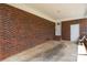 Covered carport area with brick walls, providing shelter for vehicles and extra storage space at 128 Wandering Ln, Bessemer City, NC 28016