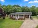 Charming brick home with a well-manicured lawn, covered front porch, and ample natural light at 128 Wandering Ln, Bessemer City, NC 28016