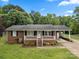 Charming brick home with a well-manicured lawn, covered front porch, and ample natural light at 128 Wandering Ln, Bessemer City, NC 28016