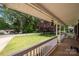 Inviting front porch with views of the serene surroundings and lush green lawn at 128 Wandering Ln, Bessemer City, NC 28016