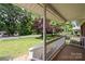 Cozy front porch with white railings and a view of the lush green lawn and trees at 128 Wandering Ln, Bessemer City, NC 28016