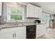 Well-lit kitchen featuring white cabinets, black appliances, a stainless steel sink, and granite countertops at 128 Wandering Ln, Bessemer City, NC 28016