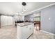 Open floorplan showing kitchen island with granite countertop with dining area and living room beyond at 128 Wandering Ln, Bessemer City, NC 28016