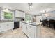 Open floorplan showing kitchen island with granite countertop and stainless dishwasher, with dining area beyond at 128 Wandering Ln, Bessemer City, NC 28016