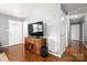 Cozy living room with hardwood floors, and a large television above the wood cabinet at 128 Wandering Ln, Bessemer City, NC 28016