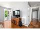 Bright living room with hardwood floors, white doors, and access to the porch through a sliding glass door at 128 Wandering Ln, Bessemer City, NC 28016