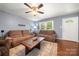 Comfortable living room featuring hardwood floors, ceiling fan, and natural light from the window by the front door at 128 Wandering Ln, Bessemer City, NC 28016