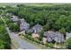 Aerial view showcasing a neighborhood with meticulously landscaped yards and well-maintained homes at 13837 Grand Palisades Pkwy, Charlotte, NC 28278