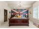Luxurious bedroom with a statement wall featuring a Union Jack design and a decorative chandelier at 13837 Grand Palisades Pkwy, Charlotte, NC 28278