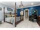 Spacious bedroom with a four-poster bed, blue accent wall, and a stylish wrought iron design at 13837 Grand Palisades Pkwy, Charlotte, NC 28278