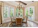 Charming breakfast nook with a round glass table, chandelier, and plantation shutters at 13837 Grand Palisades Pkwy, Charlotte, NC 28278