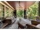 Comfortable covered porch with seating area, ceiling fan, and outdoor views at 13837 Grand Palisades Pkwy, Charlotte, NC 28278