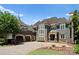 Elegant home with stone accents, multi-car garage and manicured landscaping at 13837 Grand Palisades Pkwy, Charlotte, NC 28278