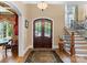 Grand foyer with hardwood floors, a staircase, and double front doors at 13837 Grand Palisades Pkwy, Charlotte, NC 28278