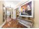Grand foyer with hardwood floors, ornate console table, and elegant artwork at 13837 Grand Palisades Pkwy, Charlotte, NC 28278