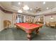 A recreation space with a pool table, living area, and custom lighting, perfect for entertaining at 13837 Grand Palisades Pkwy, Charlotte, NC 28278