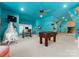 Unique game room with custom ocean-themed murals, foosball table, and bright turquoise walls at 13837 Grand Palisades Pkwy, Charlotte, NC 28278