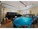 A spacious garage featuring a black SUV, a blue sports car, and ample room for parking and storage at 13837 Grand Palisades Pkwy, Charlotte, NC 28278