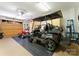A well-organized garage with a golf cart, an ATV, storage cabinets, and a diamond-plated rubber floor at 13837 Grand Palisades Pkwy, Charlotte, NC 28278
